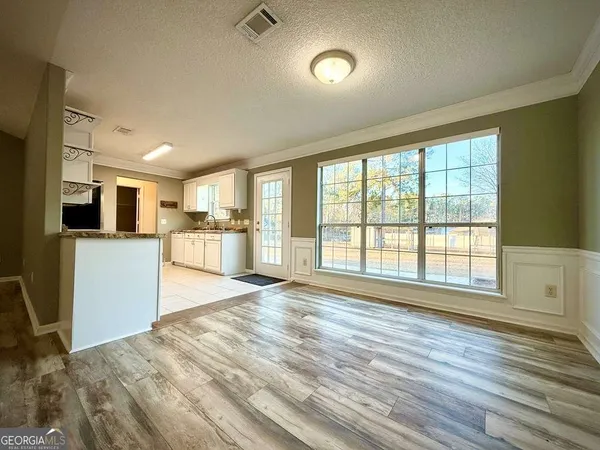 a kitchen with cabinets stainless steel appliances and a counter space