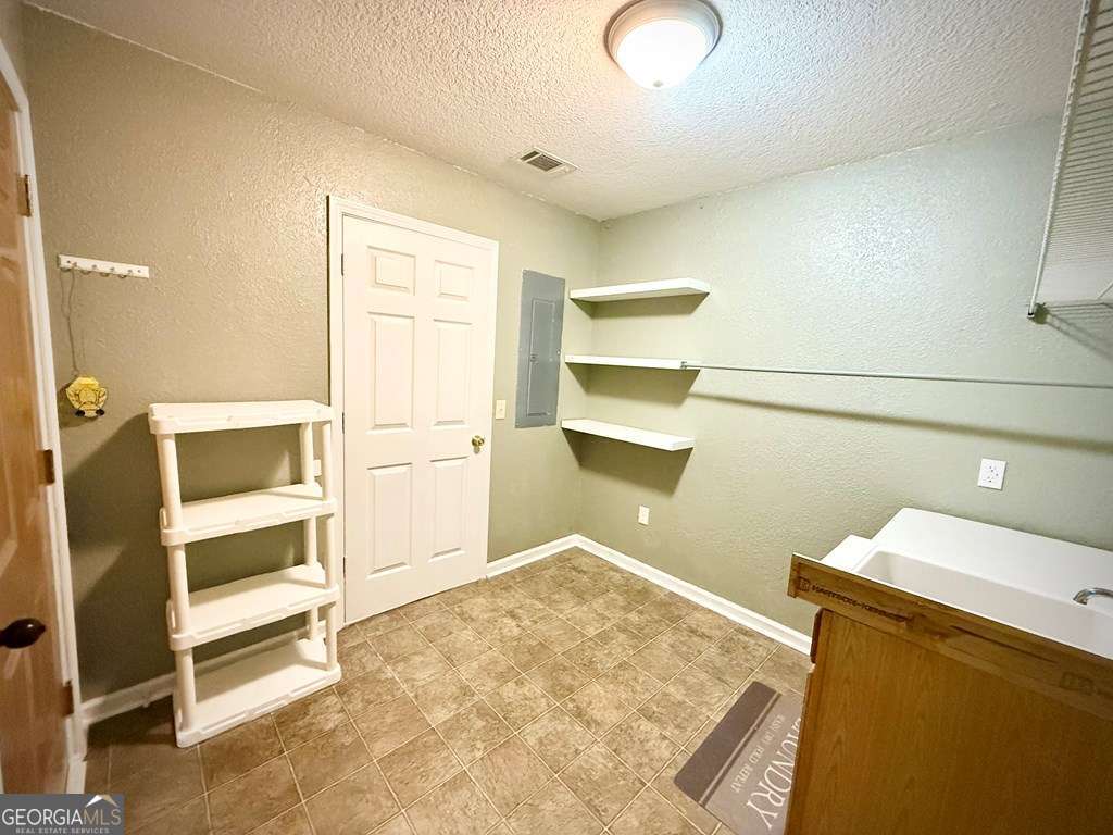 14 Quail Circle Hazlehurst, GA 31539 - Photo 19 of 54 a view of walk in closet with empty racks