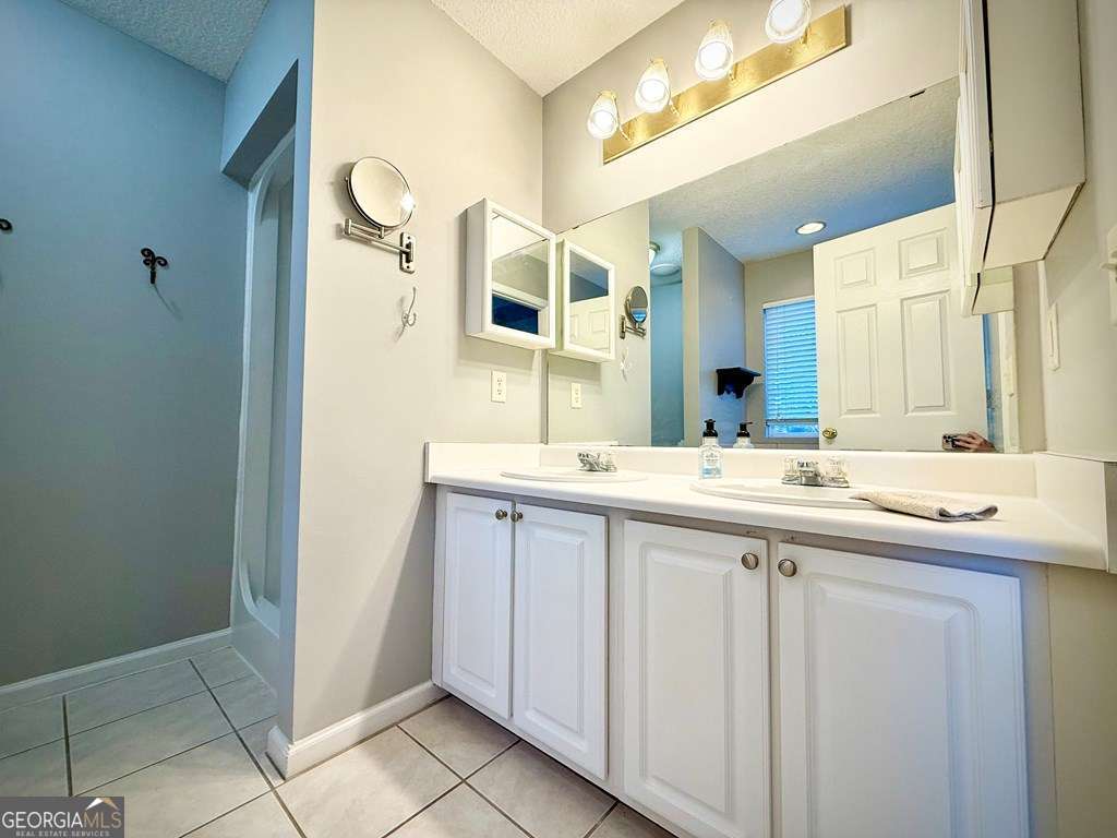 14 Quail Circle Hazlehurst, GA 31539 - Photo 24 of 54 a bathroom with a double vanity sink and mirror