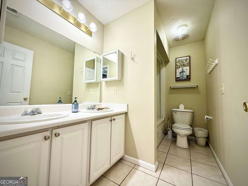 14 Quail Circle Hazlehurst, GA 31539 - Photo 30 of 54 a bathroom with a toilet sink and mirror