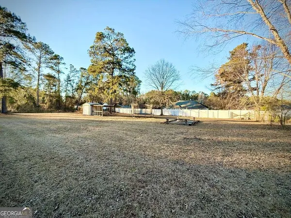 a view of a backyard with sitting area