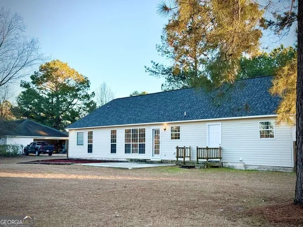a view of a house with a backyard