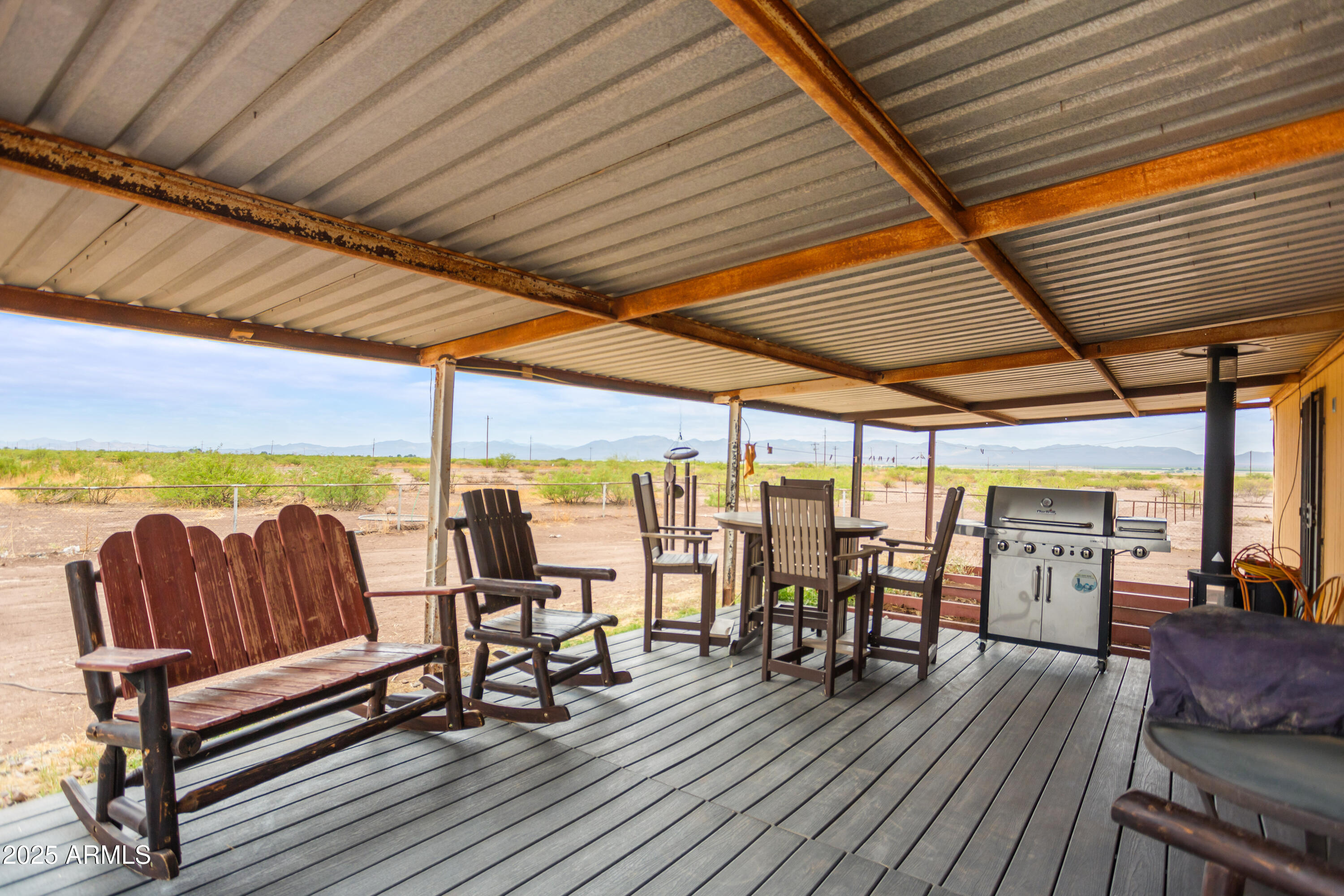 4274 West Lee Road McNeal, AZ 85617 - Photo 17 of 43 a roof deck with outdoor seating and wooden floor