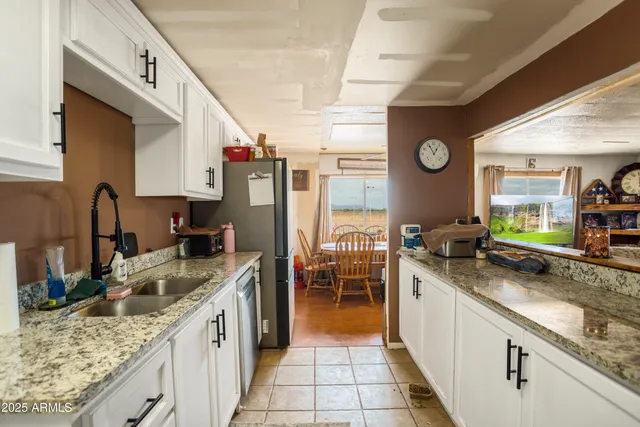 a kitchen with granite countertop lots of counter top space and stainless steel appliances