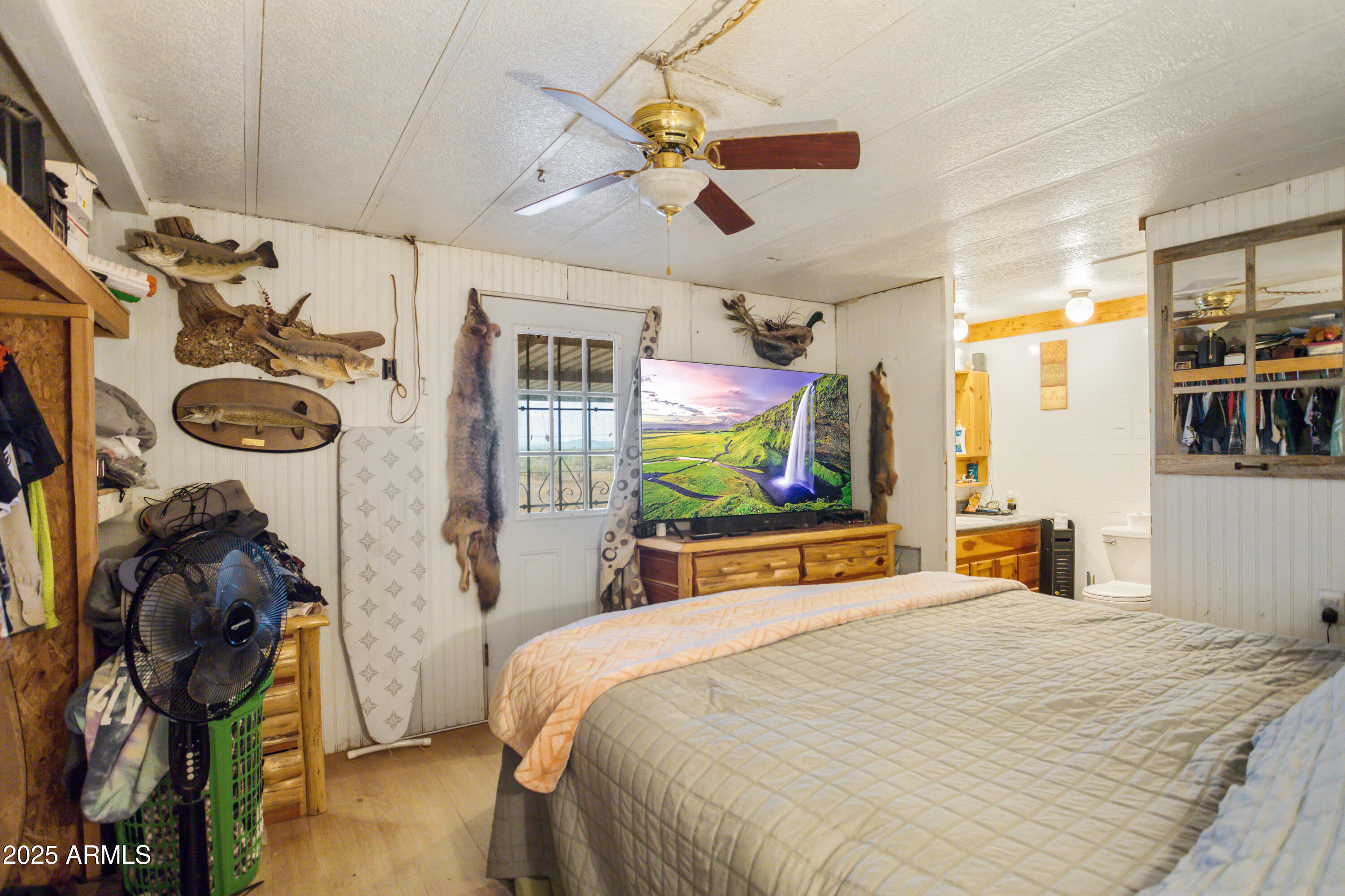 4274 West Lee Road McNeal, AZ 85617 - Photo 10 of 43 a bedroom with a bed and a flat tv screen