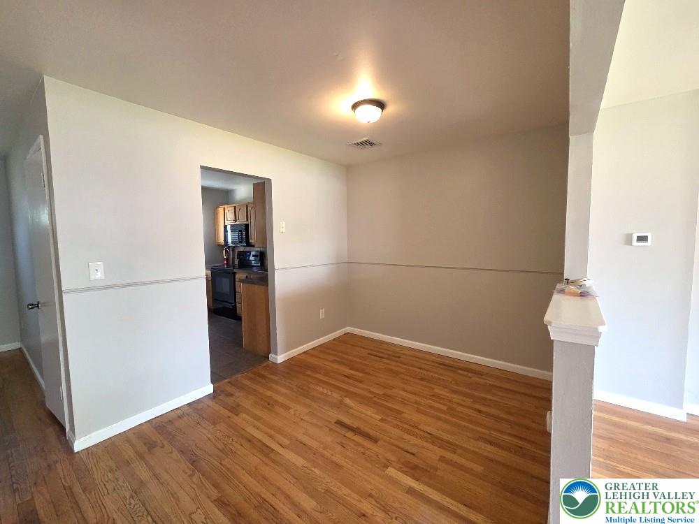 1747 Schoenersville Road Bethlehem, PA 18018 - Photo 5 of 13 Rich hardwood floors extend through this ample dining space, leading to a functional kitchen.