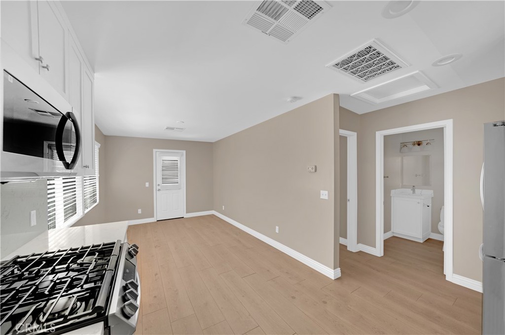 6735 B Yellowstone Drive Riverside, CA 92506 - Photo 2 of 15 a view of a livingroom with wooden floor and a ceiling fan