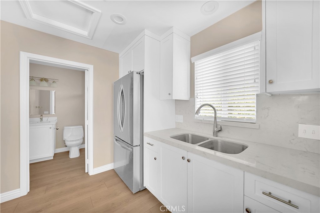 6735 B Yellowstone Drive Riverside, CA 92506 - Photo 7 of 15 a kitchen with stainless steel appliances granite countertop a sink and a refrigerator