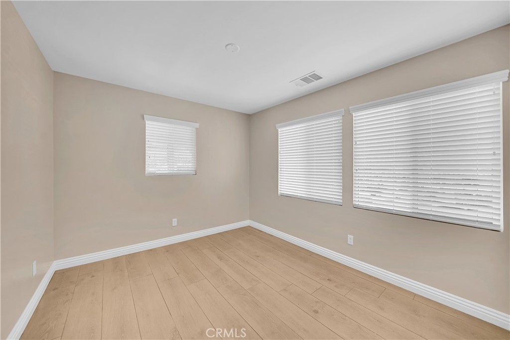 6735 B Yellowstone Drive Riverside, CA 92506 - Photo 8 of 15 wooden floor in an empty room with a window