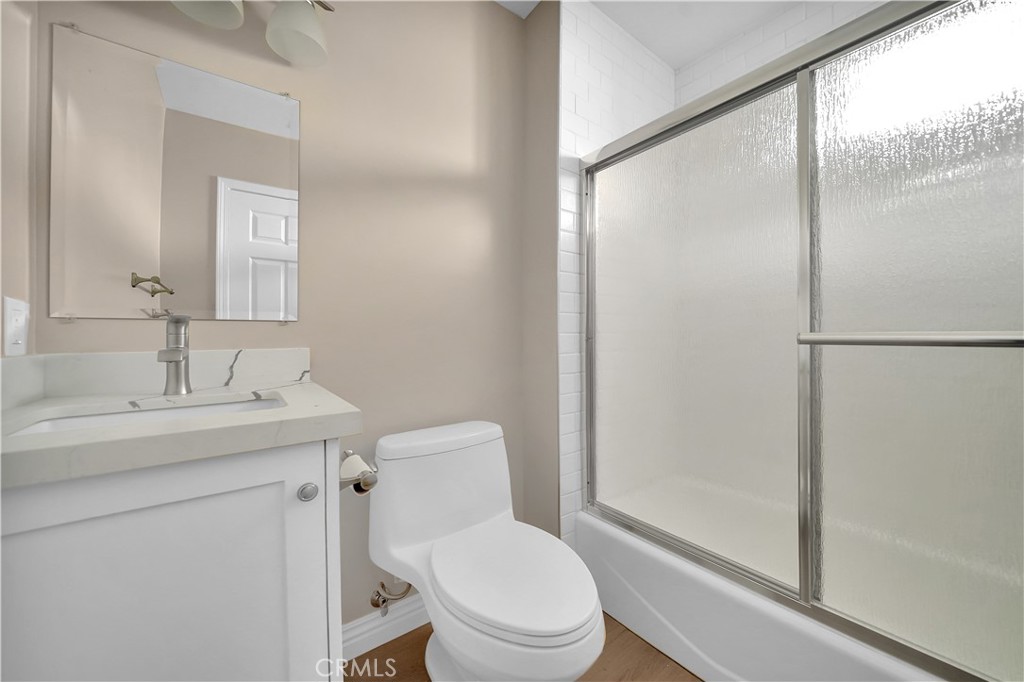 6735 B Yellowstone Drive Riverside, CA 92506 - Photo 10 of 15 a bathroom with a toilet a sink and a mirror