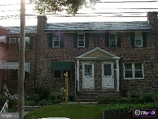 232 Hampden Road Upper Darby, PA 19082 - Photo 1 of 1 a view of a house with brick walls and a yard with plants