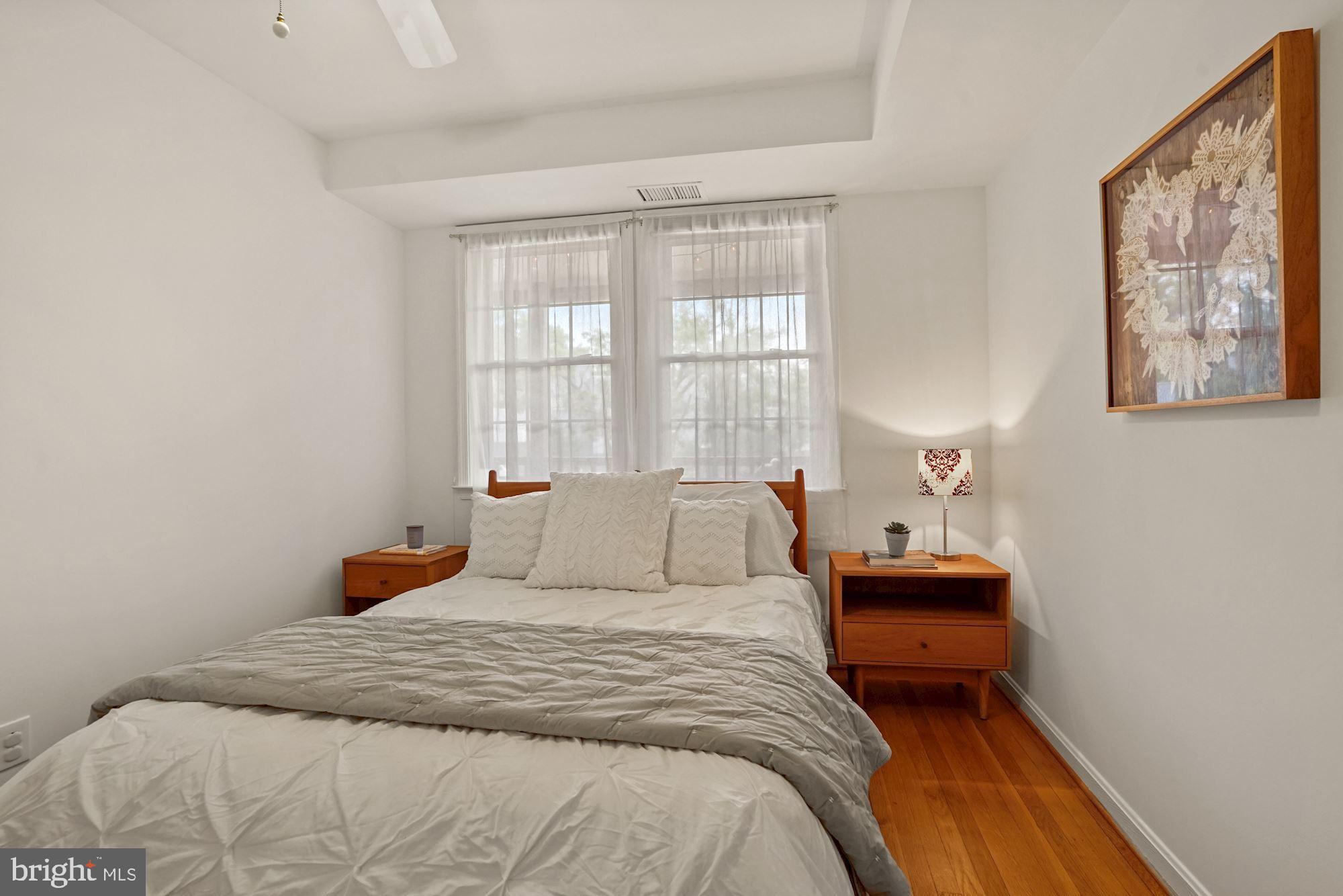 9 Russell Road, Unit D Alexandria, VA 22301 - Photo 24 of 29 a bedroom with a bed and wooden floor