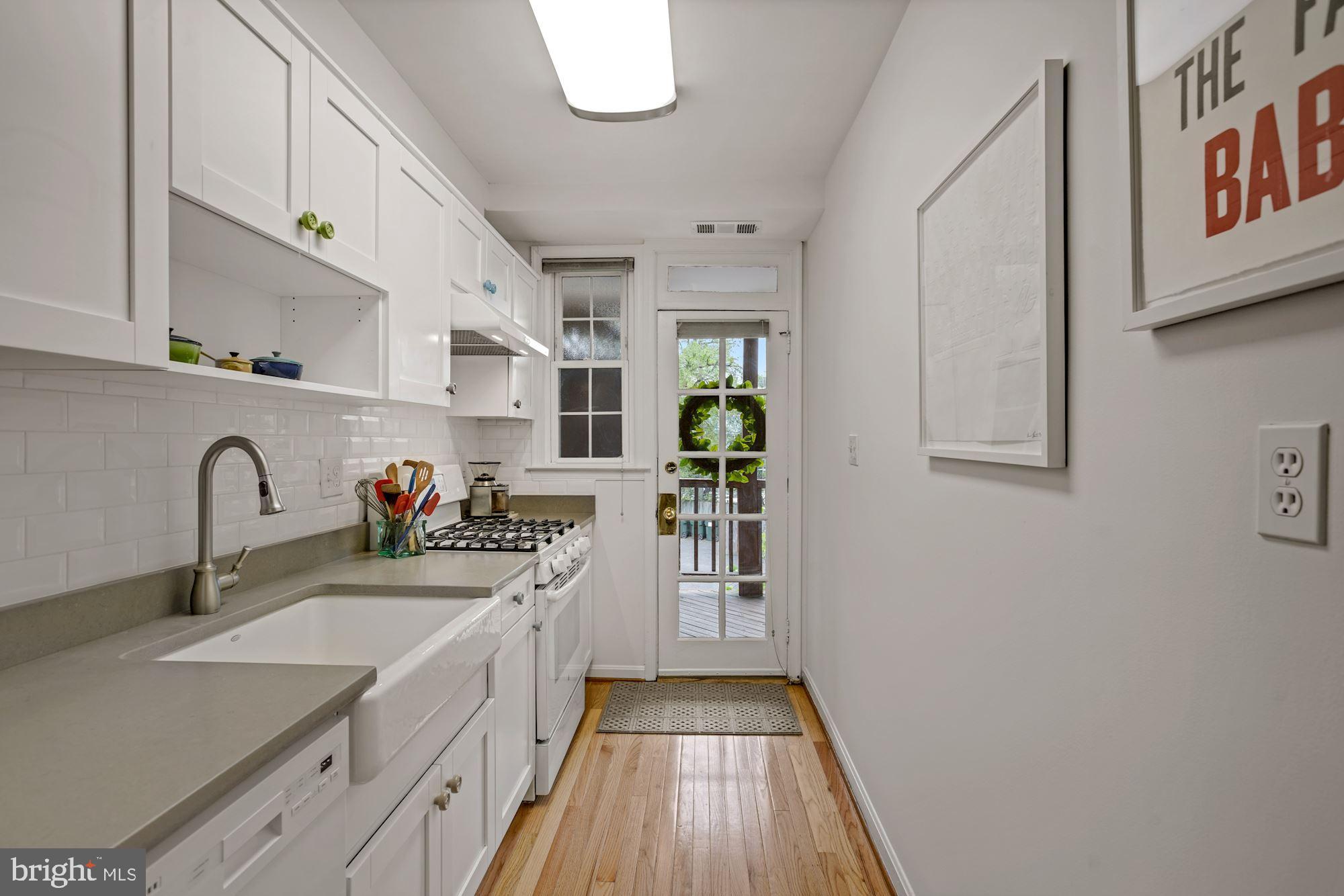 9 Russell Road, Unit D Alexandria, VA 22301 - Photo 8 of 29 a kitchen with stainless steel appliances granite countertop a sink stove and refrigerator