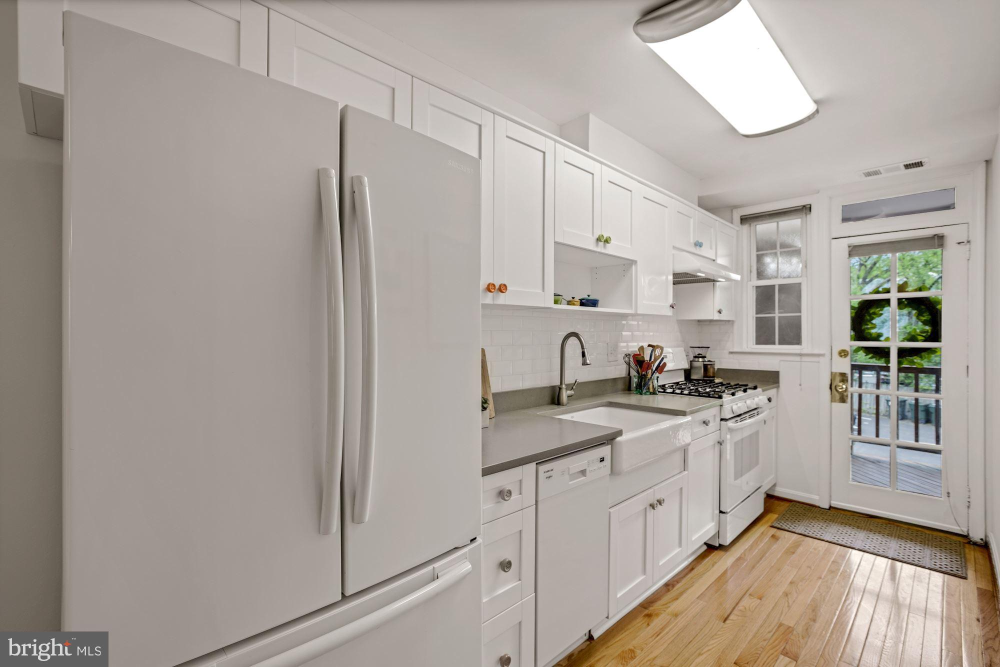 9 Russell Road, Unit D Alexandria, VA 22301 - Photo 10 of 29 a kitchen with stainless steel appliances a sink cabinets and a window
