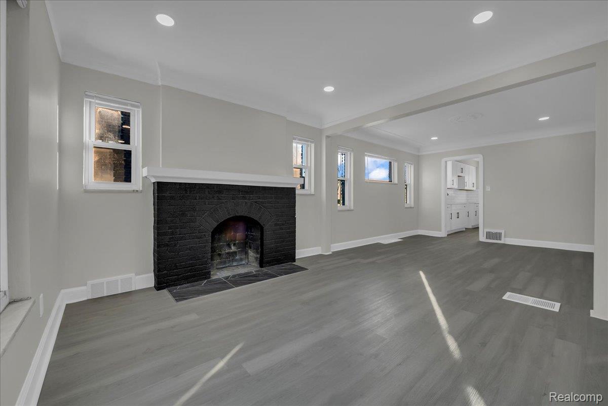 16717 Fielding Street Detroit, MI 48219 - Photo 10 of 46 Unfurnished living room featuring wood finished floors, recessed lighting, a fireplace, and beamed ceiling
