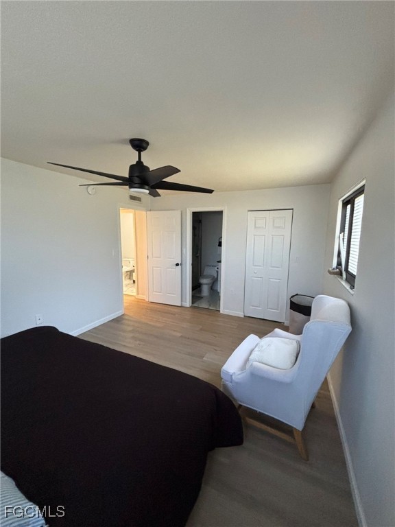 5713 Foxlake Drive, Unit 4 North Fort Myers, FL 33917 - Photo 7 of 13 a bedroom with a bed and a chandelier