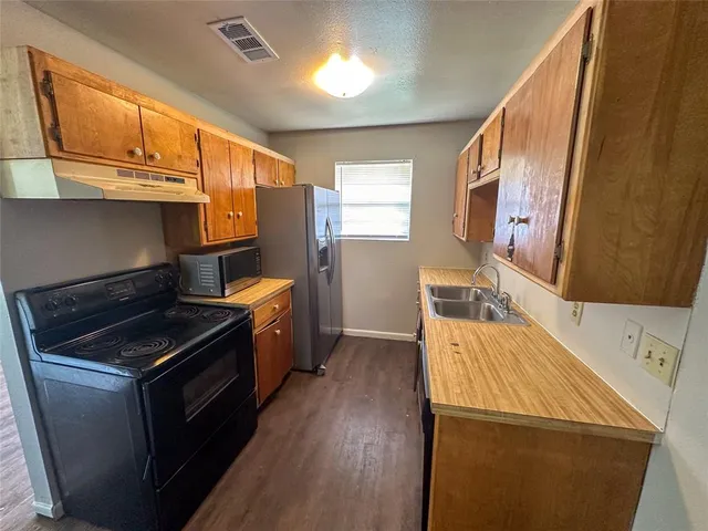 a kitchen with a stove and a refrigerator