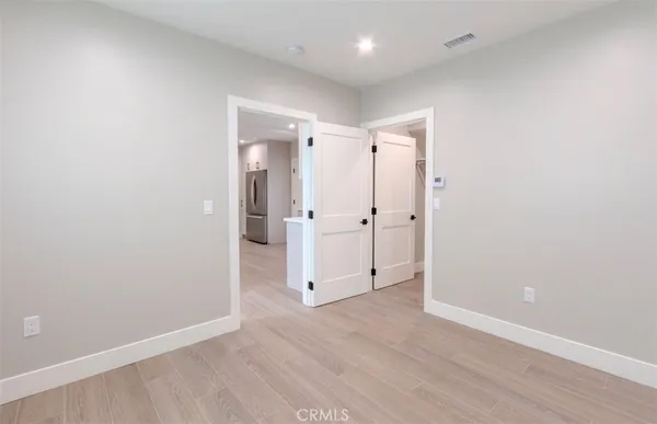 a bathroom with a toilet and a glass door shower