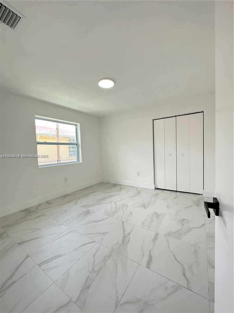 1443 Northwest 34th Street Miami, FL 33142 - Photo 9 of 11 a view of an empty room with a window