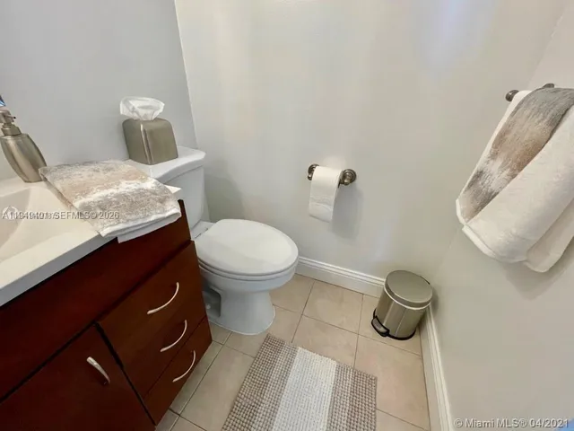 a spacious bathroom with a double vanity sink toilet mirror and shower