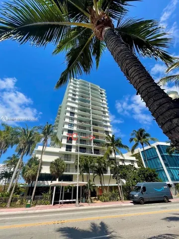 a view of a tall building next to a road