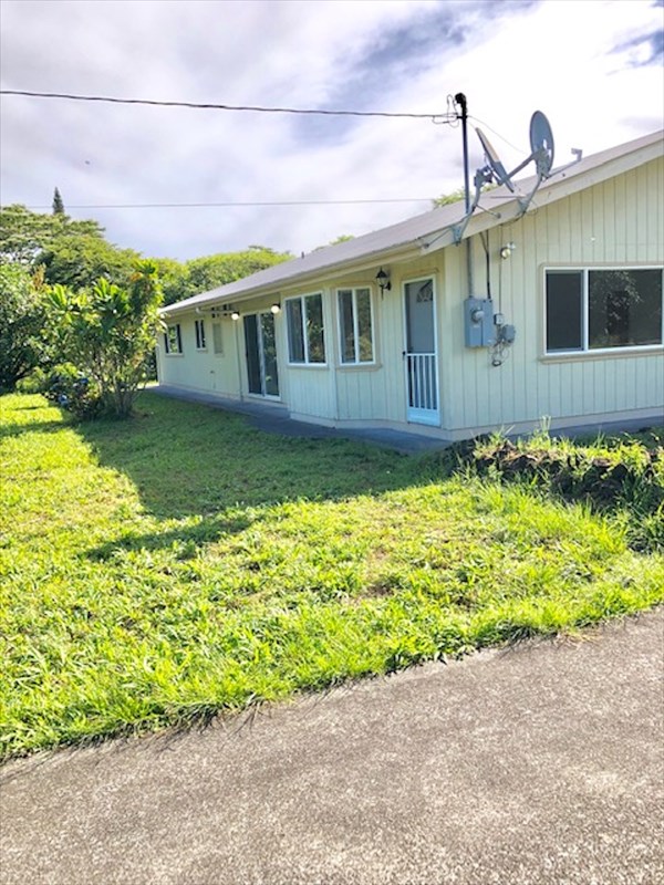 769 Ahuna Road Hilo, HI 96720 - Photo 1 of 21 a front view of a house with a yard and potted plants