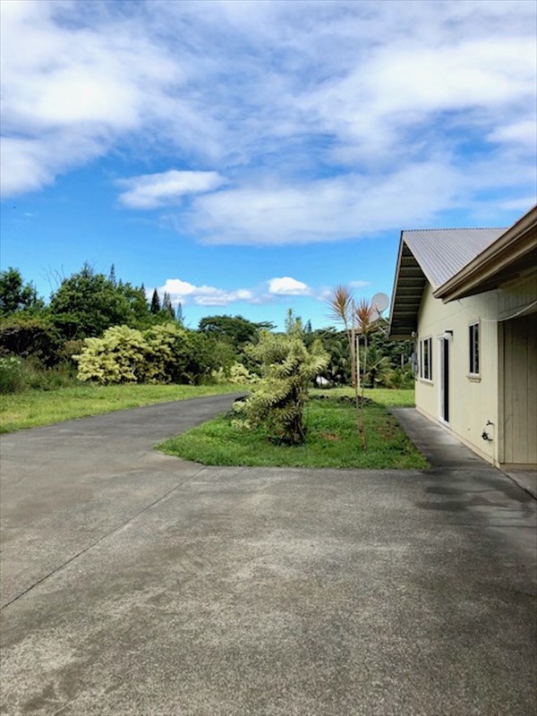 769 Ahuna Road Hilo, HI 96720 - Photo 4 of 21 a view of a house with a big yard and plants