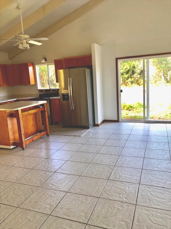 769 Ahuna Road Hilo, HI 96720 - Photo 8 of 21 a view of a kitchen with kitchen island granite countertop a refrigerator and a sink