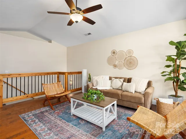 a living room with furniture and a rug