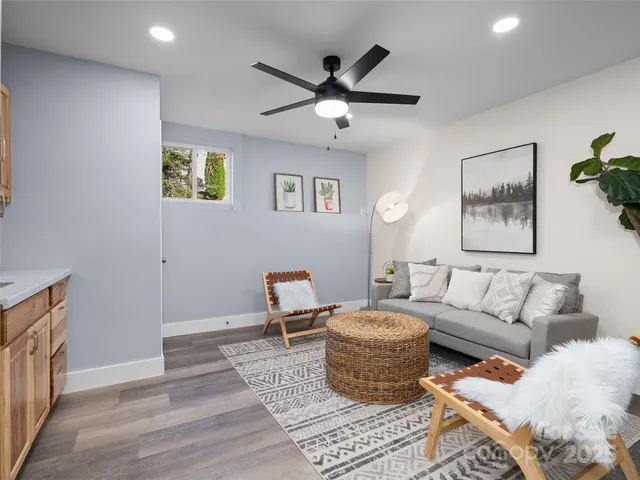 a living room with furniture and a wooden floor