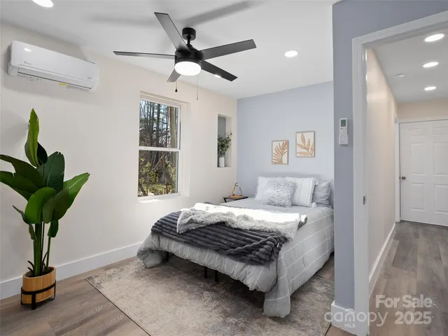 a bedroom that has a bed and a potted plant