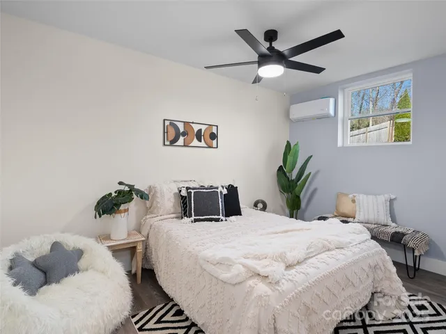 a bedroom with a bed and ceiling fan