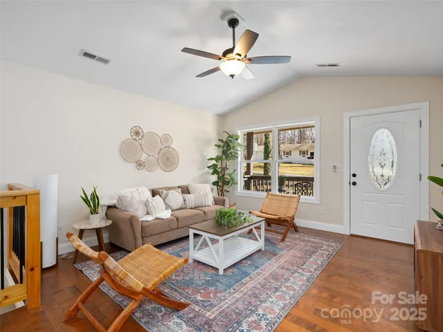 a living room with furniture a rug and a window