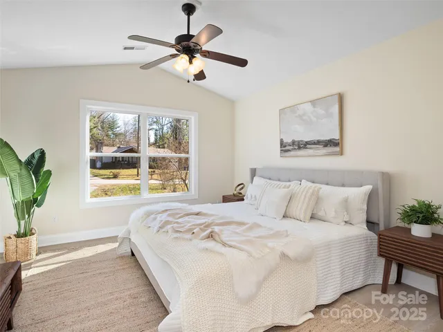 a bedroom with a large bed and a window