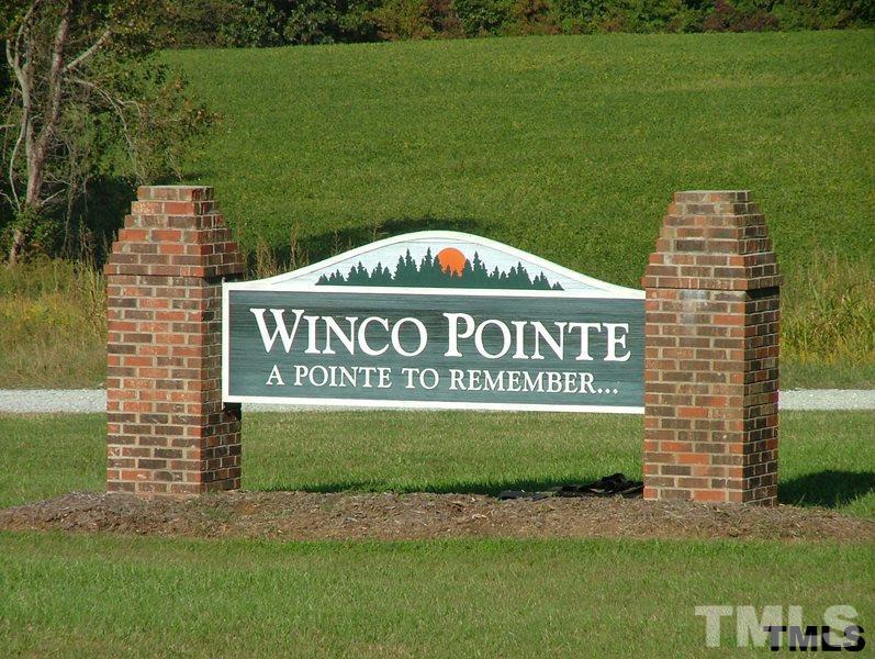 Lot 12 Winco Pointe Roxboro, NC 27574 - Photo 1 of 1 a sign of golf club on a wall next to a lake