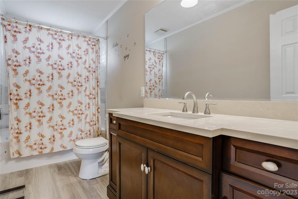 237 Diana Road Cherryville, NC 28021 - Photo 11 of 18 a bathroom with a granite countertop sink a toilet and a mirror