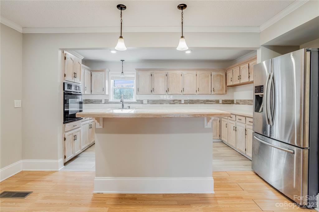 237 Diana Road Cherryville, NC 28021 - Photo 8 of 18 a kitchen with stainless steel appliances granite countertop a refrigerator a sink dishwasher a stove and white cabinets with wooden floor