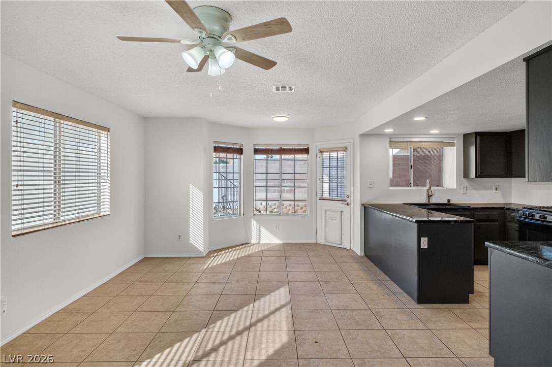 3156 Terrace View Drive Laughlin, NV 89029 - Photo 19 of 94 A well-lit kitchen and dining area features abundant natural light, creating an inviting atmosphere.