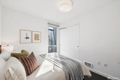 a bedroom with a bed and a painting