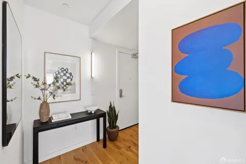 a view of a room with a mirror and a potted plant