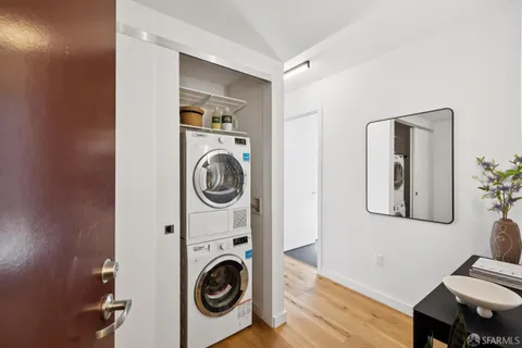 a view of a bedroom with washer and dryer