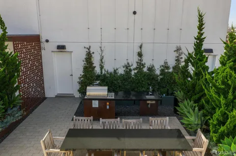 a view of a patio with table and chairs and potted plants
