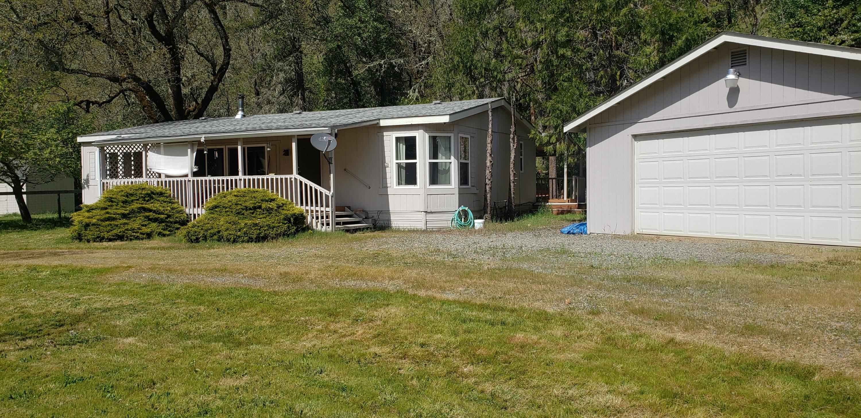 7055 Takilma Road Cave Junction, OR 97523 - Photo 2 of 27 Newer insulated garage door.