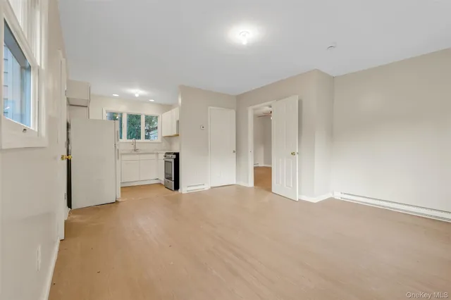 a view of an empty room with a kitchen