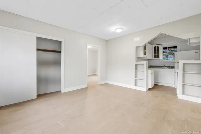 an empty room with furniture and window