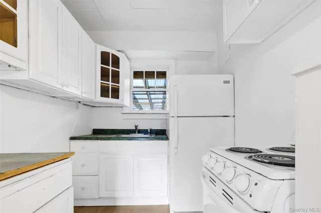 a kitchen with granite countertop cabinets stainless steel appliances and a sink