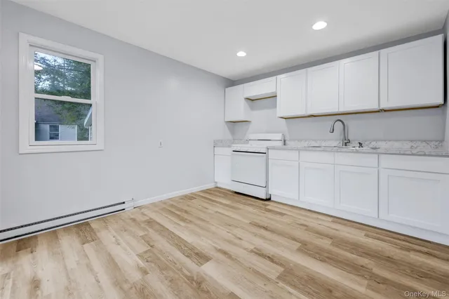 a view of kitchen with center island and windows