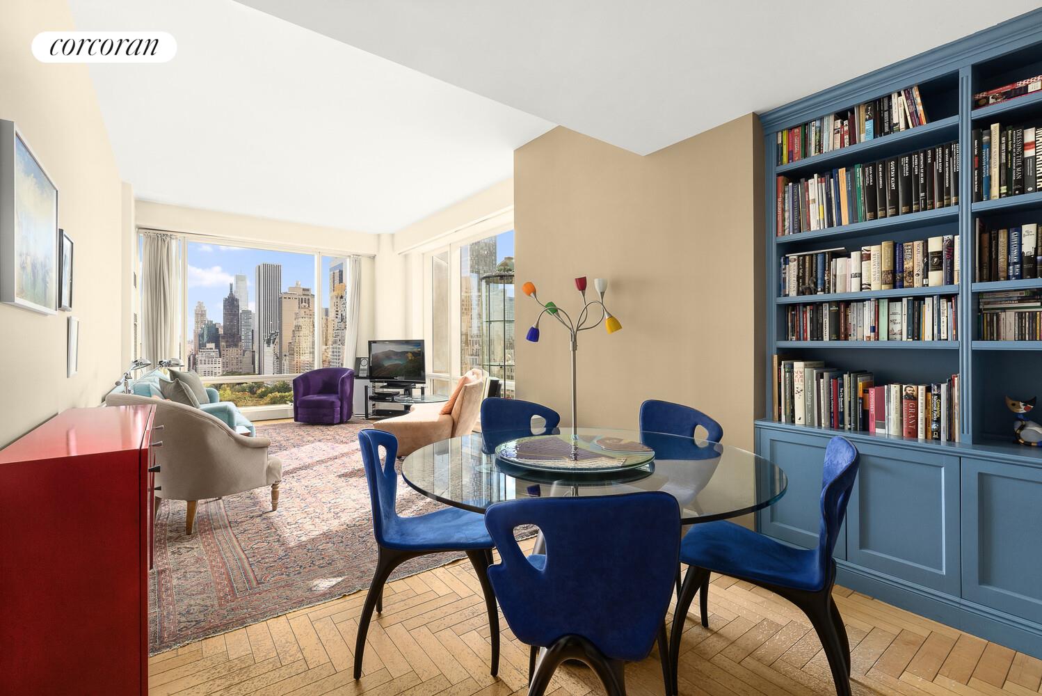 1 Central Park West, Unit 23C Manhattan, NY 10023 - Photo 7 of 10 a dining room with furniture and a book shelf