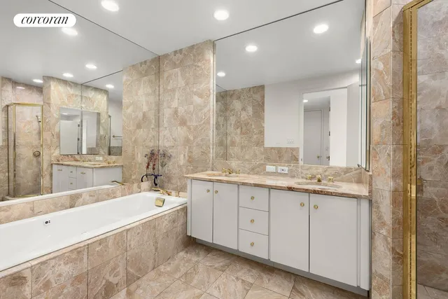 a large spacious bathroom with a granite countertop tub sink shower and mirror
