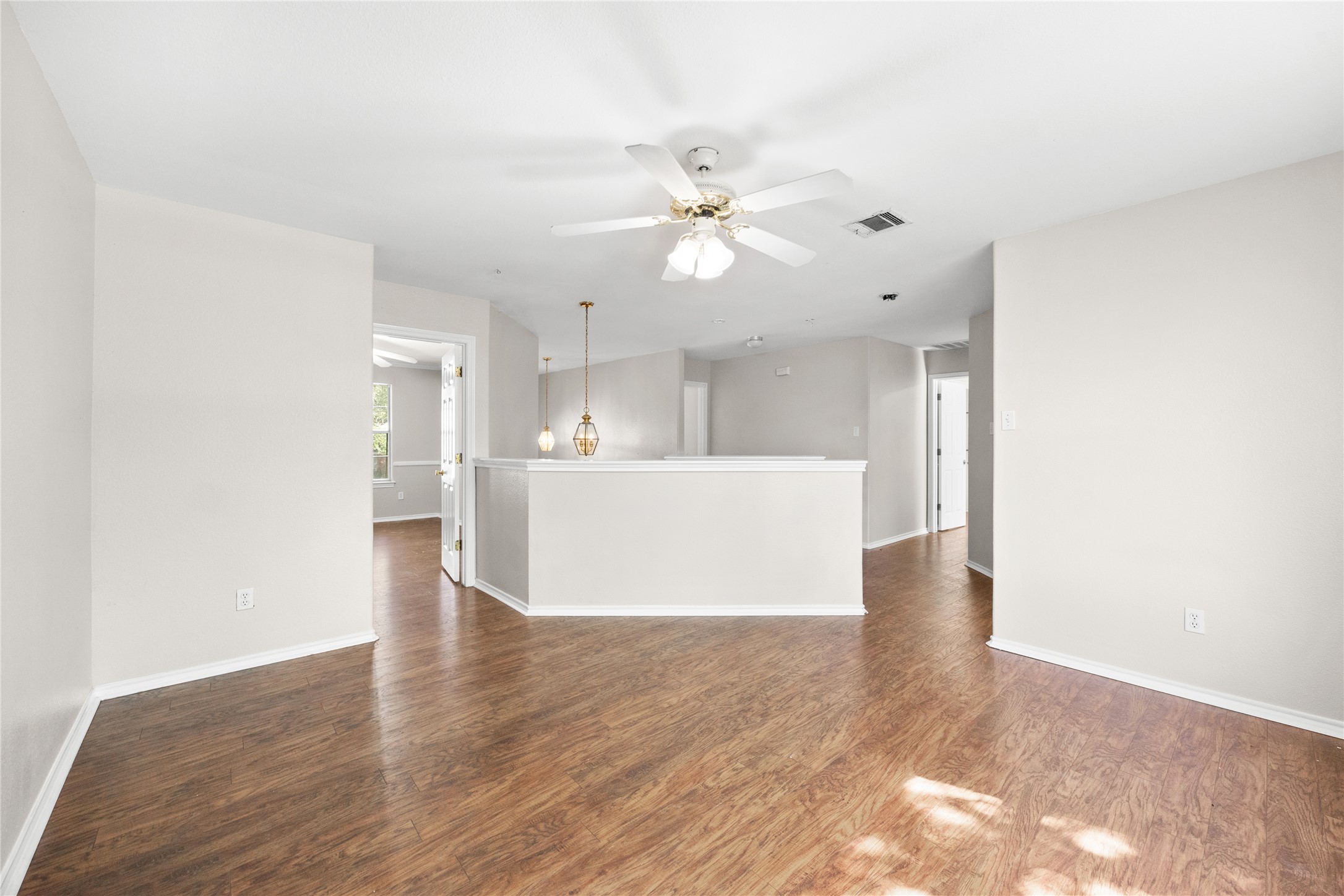 13217 Rochester Lane Austin, TX 78753 - Photo 21 of 30 Rich wood-look flooring anchors this versatile open area with clean lines.